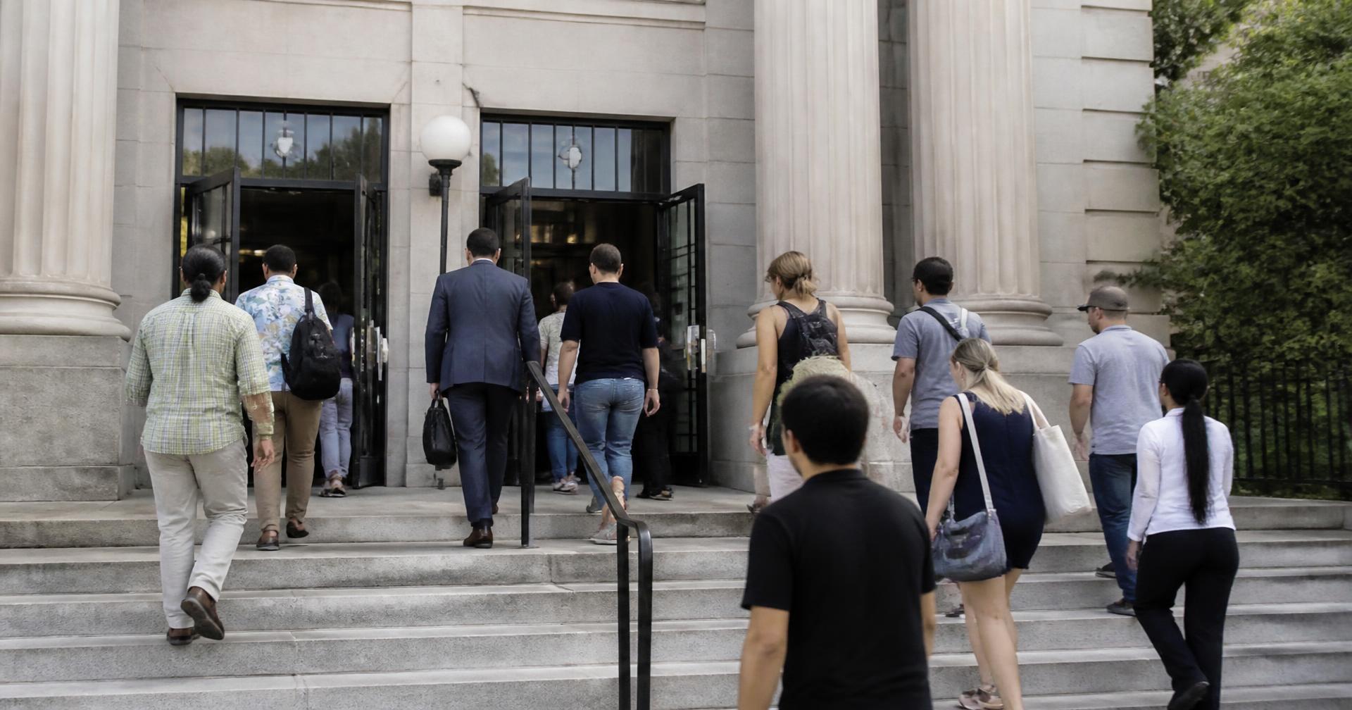 Members of the public walking up the steps of a Florida county courthouse